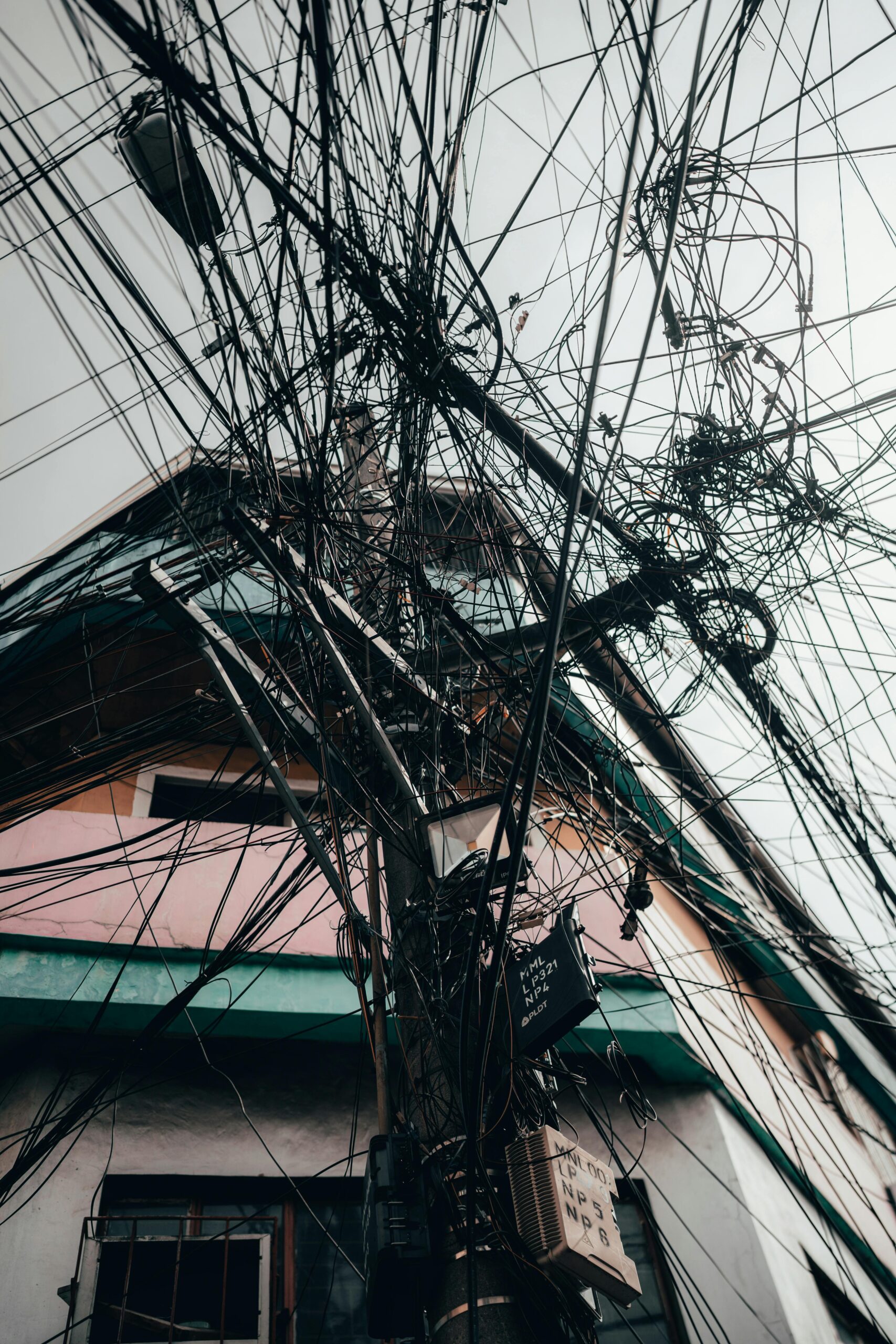 Photo by jackson tee: https://www.pexels.com/photo/electricity-lines-on-pylon-near-building-14827001/